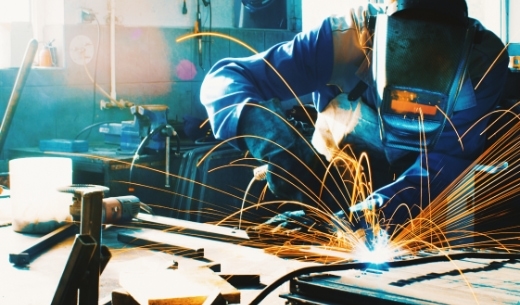 A worker welding some steel frames