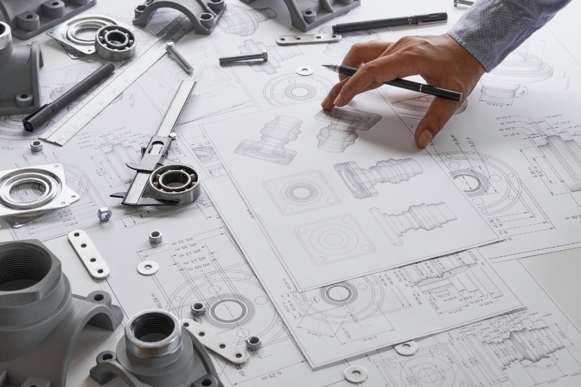 Machine blueprints on a workdesk